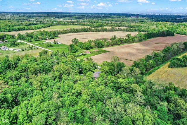 drone / aerial view featuring a rural view and a view of trees