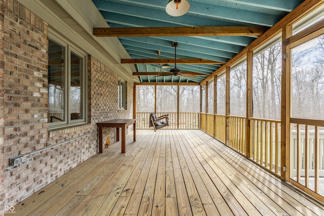 unfurnished sunroom featuring lofted ceiling and a ceiling fan