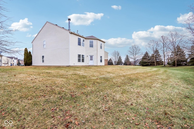 view of side of home with a yard