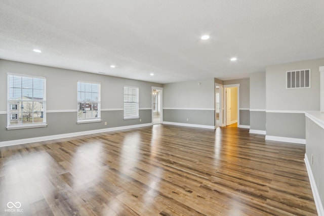 interior space with hardwood / wood-style flooring and a textured ceiling