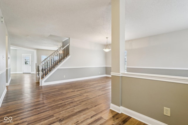 foyer entrance featuring wood-type flooring and a textured ceiling