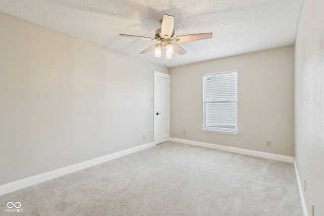 empty room with light carpet, a textured ceiling, and ceiling fan