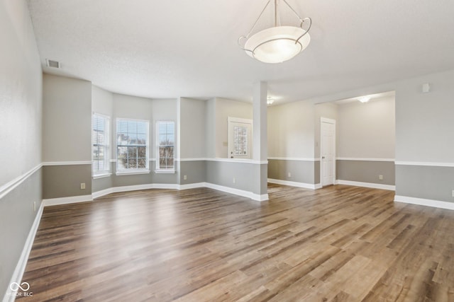 spare room featuring wood-type flooring