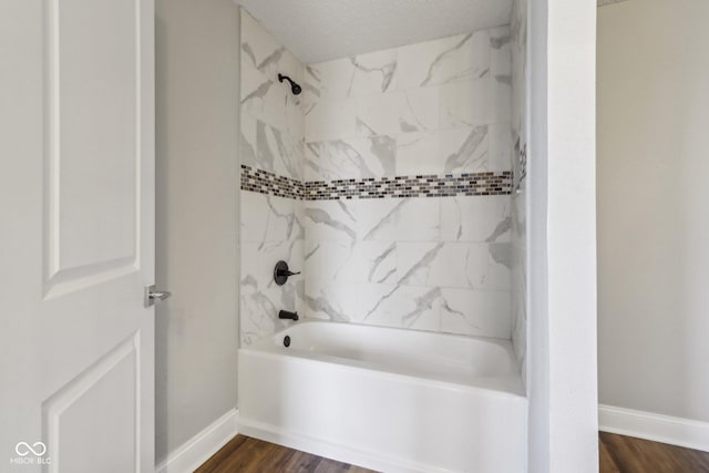 bathroom featuring hardwood / wood-style floors and tiled shower / bath