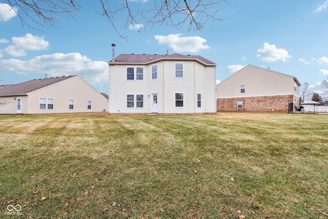 back of house featuring a lawn