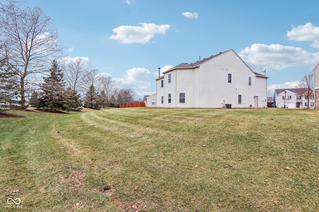 view of side of home with a lawn