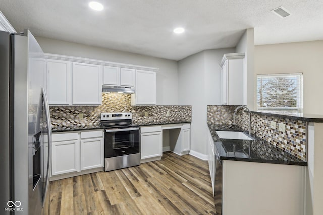 kitchen featuring stainless steel appliances, hardwood / wood-style flooring, sink, and white cabinets