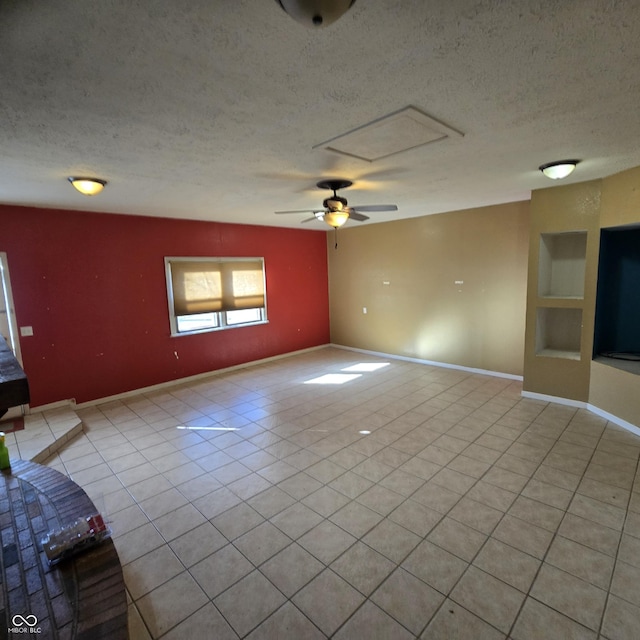 unfurnished living room with light tile patterned flooring, built in features, ceiling fan, and a textured ceiling