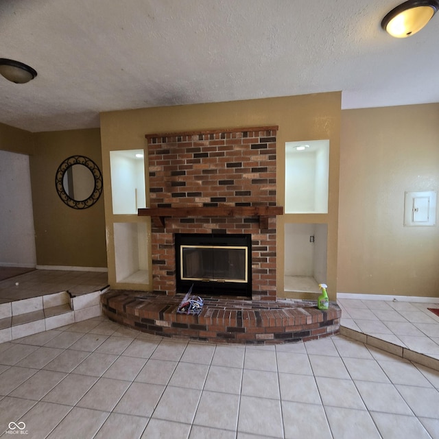 unfurnished living room with a textured ceiling, a brick fireplace, and light tile patterned floors