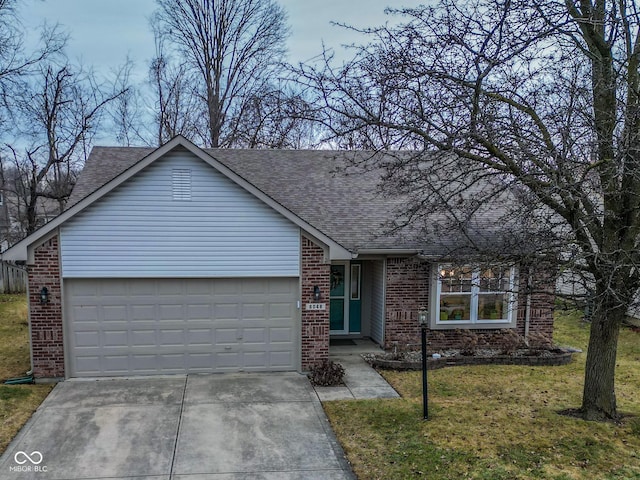 ranch-style home with a garage and a front yard