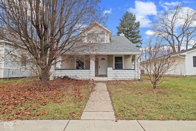 bungalow-style home featuring a porch and a front yard