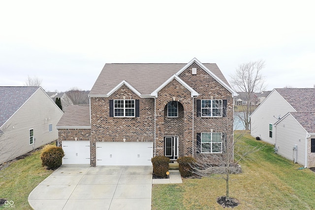 view of front of house with a garage and a front yard