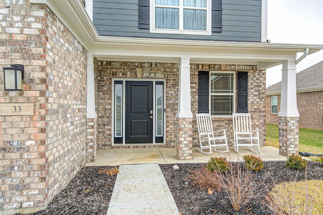 view of exterior entry featuring a porch