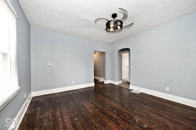 spare room featuring ceiling fan, hardwood / wood-style flooring, and a textured ceiling