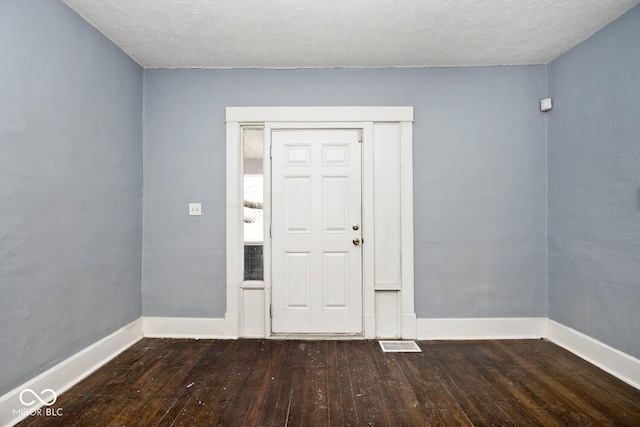 entrance foyer with hardwood / wood-style flooring and a textured ceiling