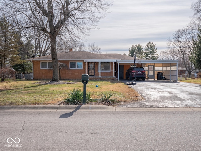 single story home featuring a carport and a front yard