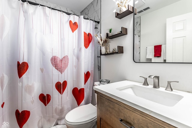 bathroom with vanity, a shower with shower curtain, and toilet