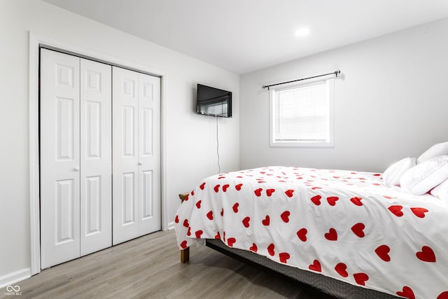 bedroom with a closet and light hardwood / wood-style flooring