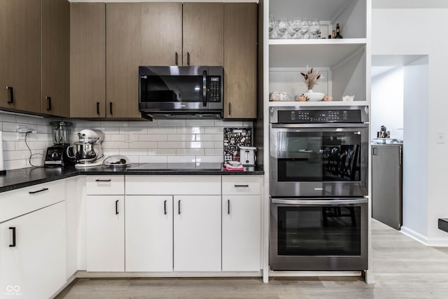 kitchen with white cabinetry, tasteful backsplash, stainless steel appliances, and light hardwood / wood-style floors