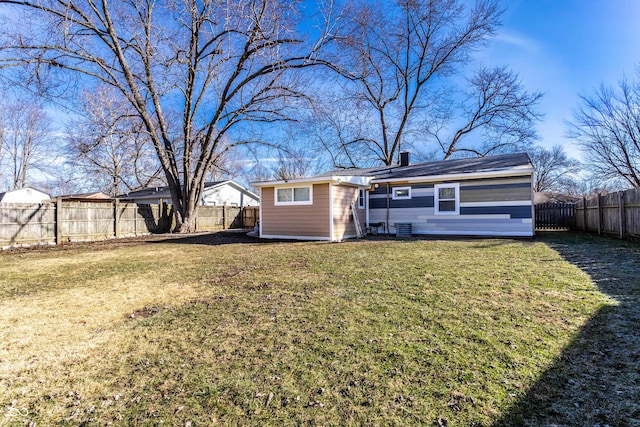 rear view of property with a lawn