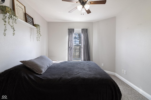 bedroom with ceiling fan, carpet flooring, and baseboards