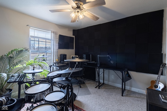 home office featuring ceiling fan, baseboards, and light colored carpet