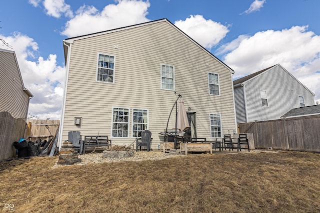 back of house featuring a patio area and fence