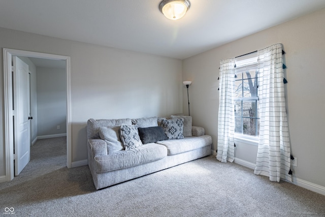 living room featuring carpet and baseboards