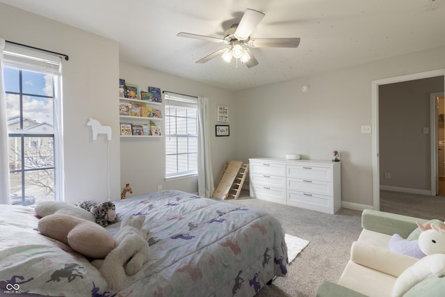 bedroom with light carpet, ceiling fan, and baseboards