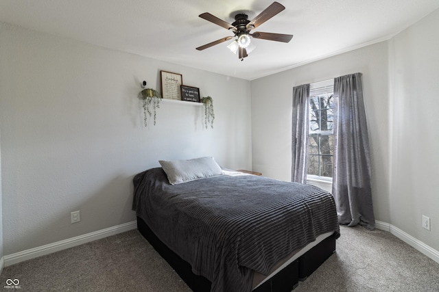 carpeted bedroom featuring ceiling fan and baseboards