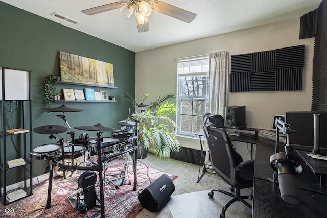 office with baseboards, visible vents, and a ceiling fan