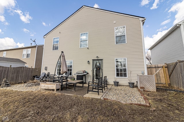 rear view of property featuring a patio and a fenced backyard