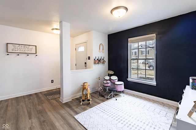 interior space featuring baseboards and wood finished floors