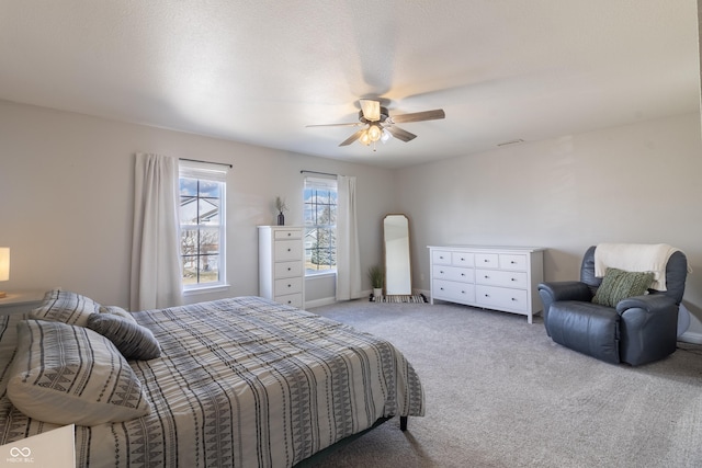 bedroom featuring light colored carpet and ceiling fan