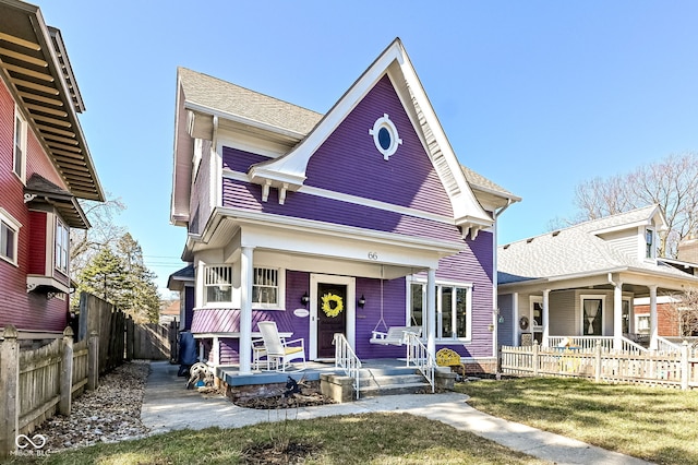 view of front of property featuring covered porch and fence