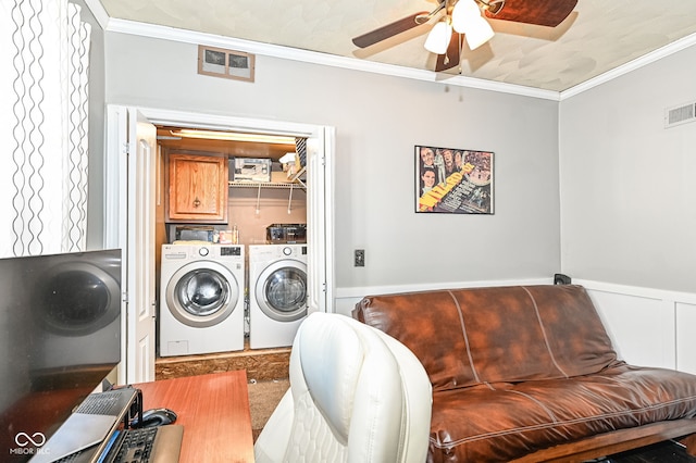 laundry area with washing machine and dryer, cabinet space, crown molding, and visible vents