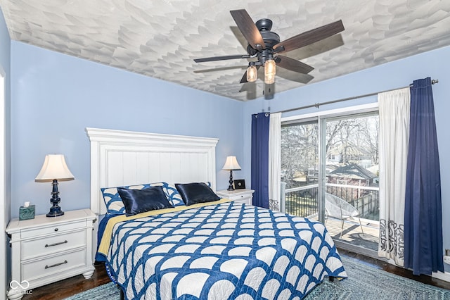 bedroom with dark wood finished floors, access to outside, and ceiling fan