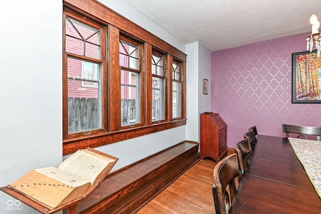 home office featuring wallpapered walls, plenty of natural light, and wood finished floors