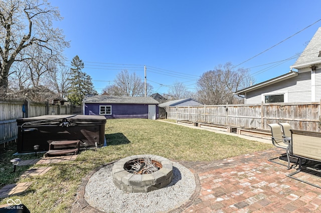 view of yard with a patio, an outdoor structure, a fenced backyard, and an outdoor fire pit