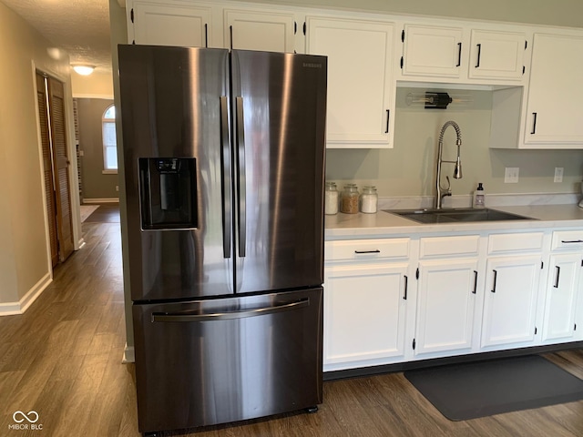 kitchen featuring stainless steel fridge with ice dispenser, dark hardwood / wood-style floors, sink, and white cabinets