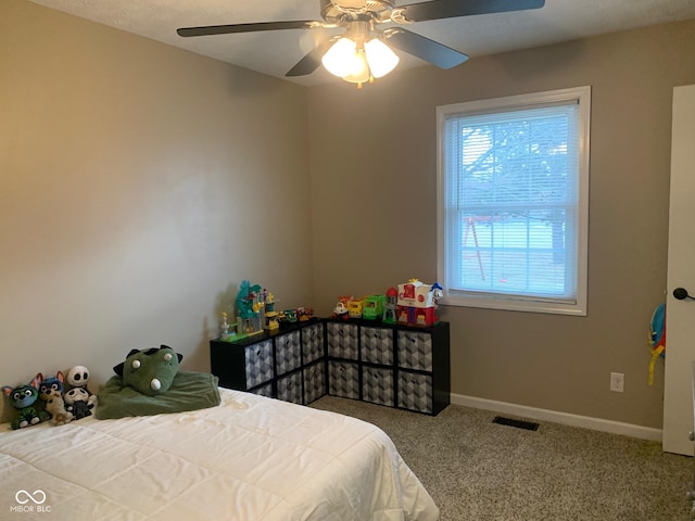 bedroom with ceiling fan and carpet flooring