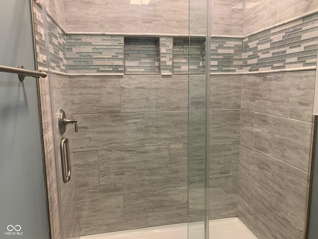 bathroom featuring a shower with door