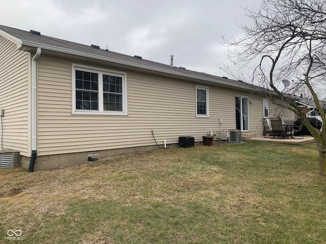 back of property with a patio, cooling unit, and a lawn