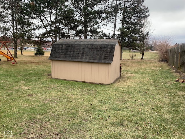 view of outdoor structure with a playground and a lawn