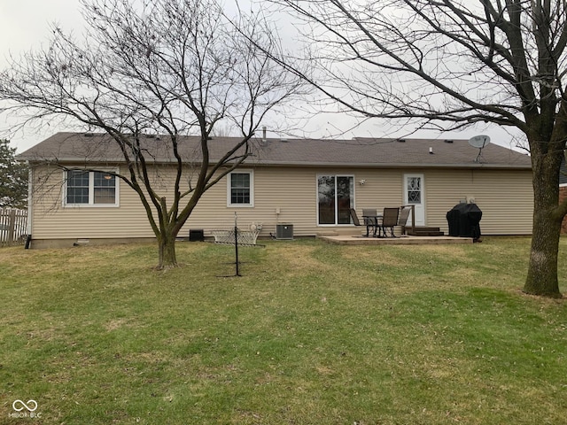 back of house with a patio and a yard