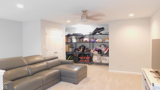 carpeted living room with ceiling fan