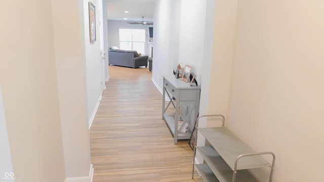 corridor with light hardwood / wood-style floors