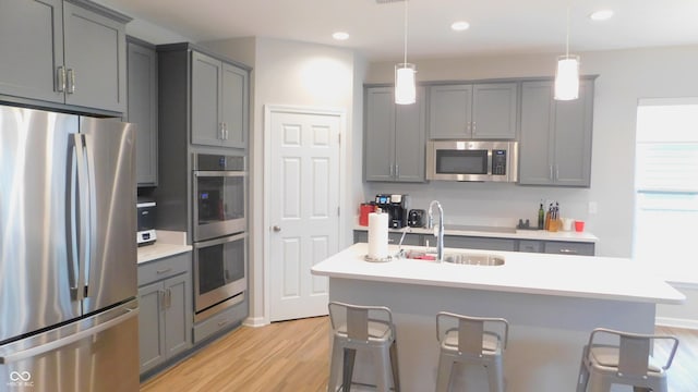 kitchen featuring gray cabinets, appliances with stainless steel finishes, and sink