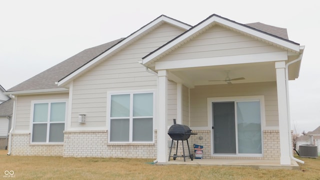 back of house featuring a patio, central AC, ceiling fan, and a lawn