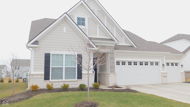 view of front of home with a garage and a front lawn